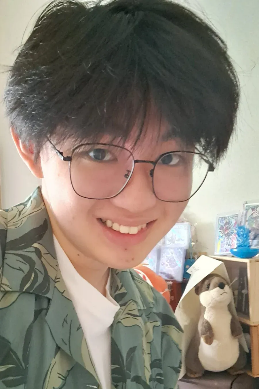Portrait of Vincent Wesley, smiling, wearing glasses and a green leaf-print shirt.